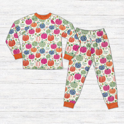 Matching family fall pajama set featuring customized floral pumpkins on a white background