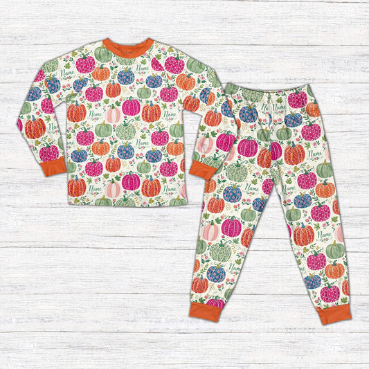 Matching family fall pajama set featuring customized floral pumpkins on a white background