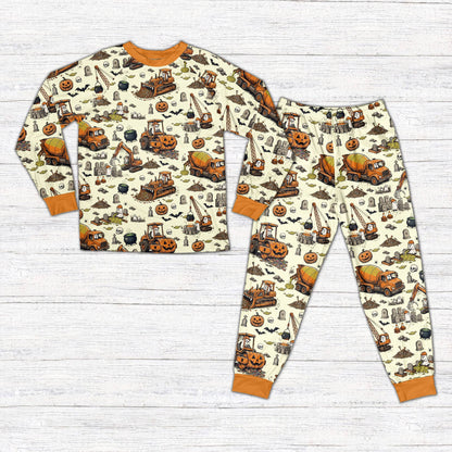 Front view of personalized Halloween pajama set featuring construction vehicles in beige