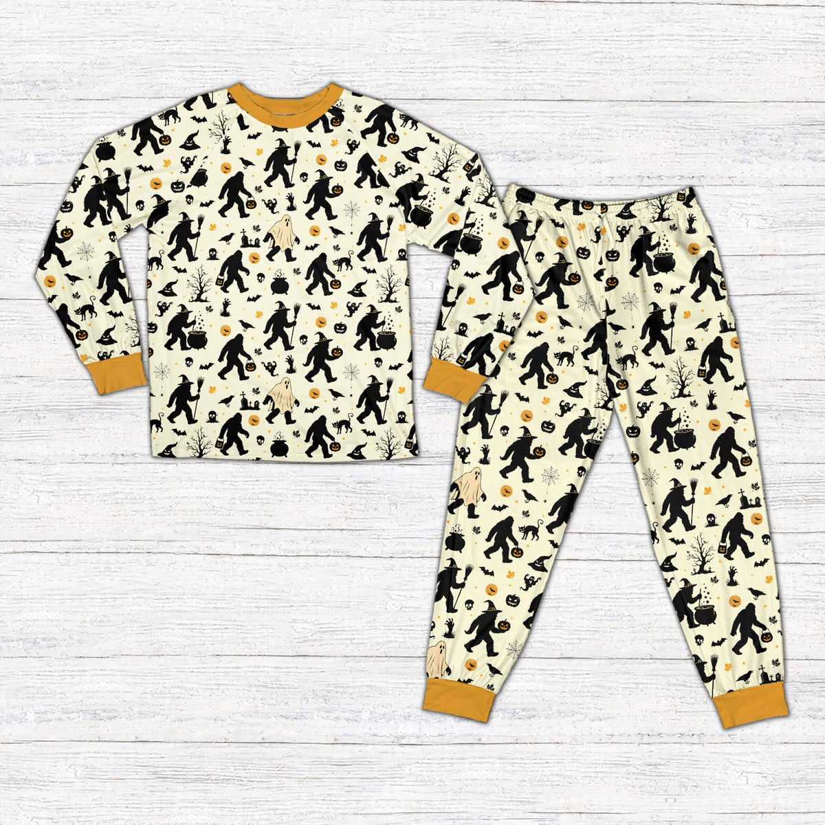 Front view of beige Halloween pajama set with Bigfoot and bat graphics