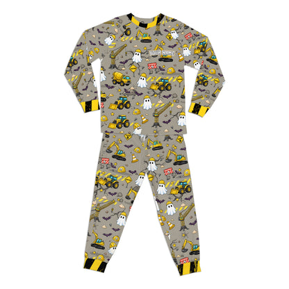 Front view highlighting the matching pajama pants with Halloween construction pattern.