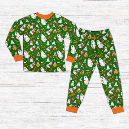 Green halloween pajama set featuring dogs and ghosts pattern, front view