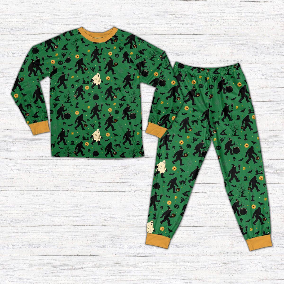 Front view of green Halloween pajama set featuring spooky trees and Bigfoot pattern
