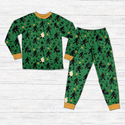 Front view of green Halloween pajama set featuring spooky trees and Bigfoot pattern