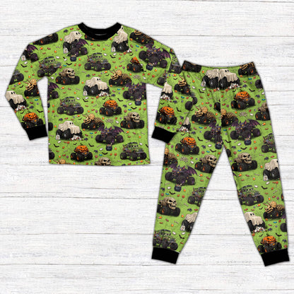 Front view of matching family holiday pajamas featuring monster trucks