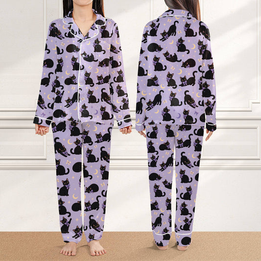 Main view of the halloween pajama set featuring playful black cats and crescent moons on a light purple background.