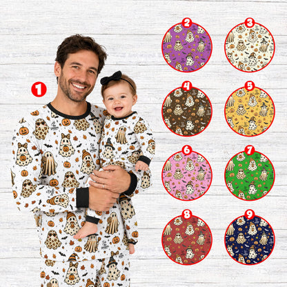 Lifestyle view of family wearing matching Halloween pajama set with cute ghosts and pumpkins