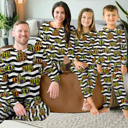Another lifestyle view of the family matching outfits featuring neon pumpkins