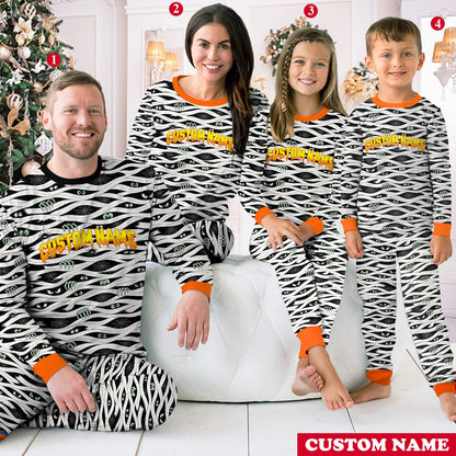 Lifestyle view of a family wearing the matching halloween mummy pajama sets