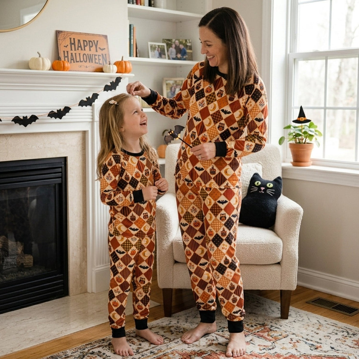 Family wearing matching Halloween patchwork pajamas, lifestyle view