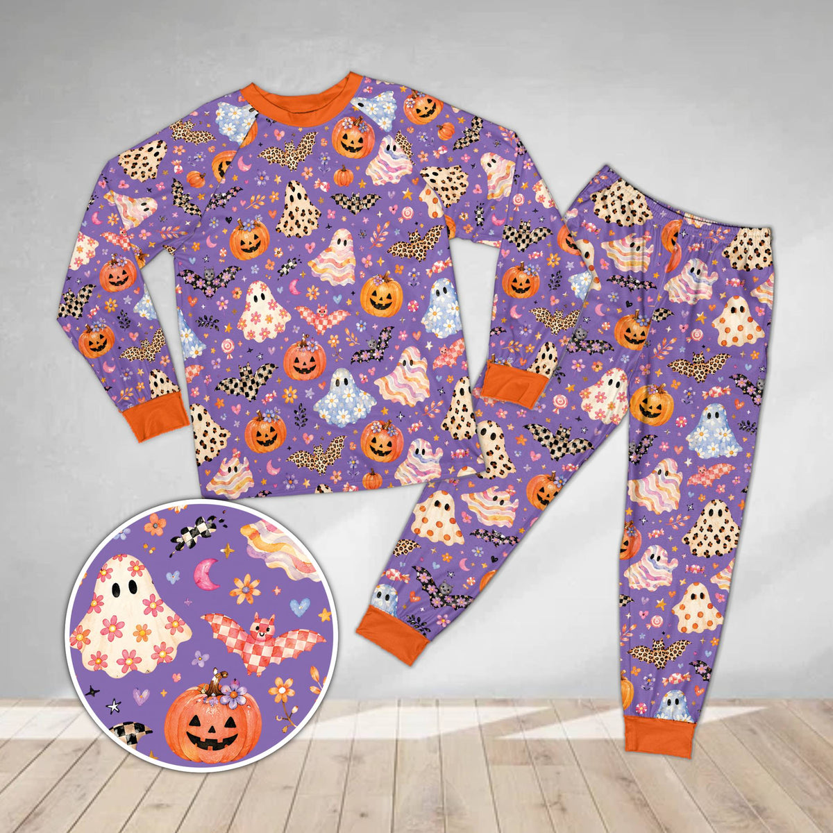 Holiday matching family pajamas with floral ghosts and patterned bats on purple background, front view