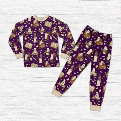 Matching family holiday pajamas with purple background and Halloween elements, front view