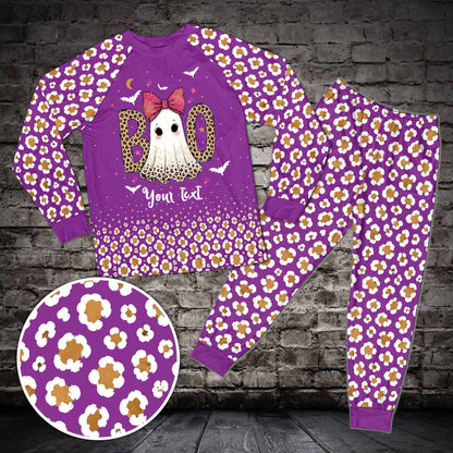 Front view of purple matching family pajamas with ghost and bats