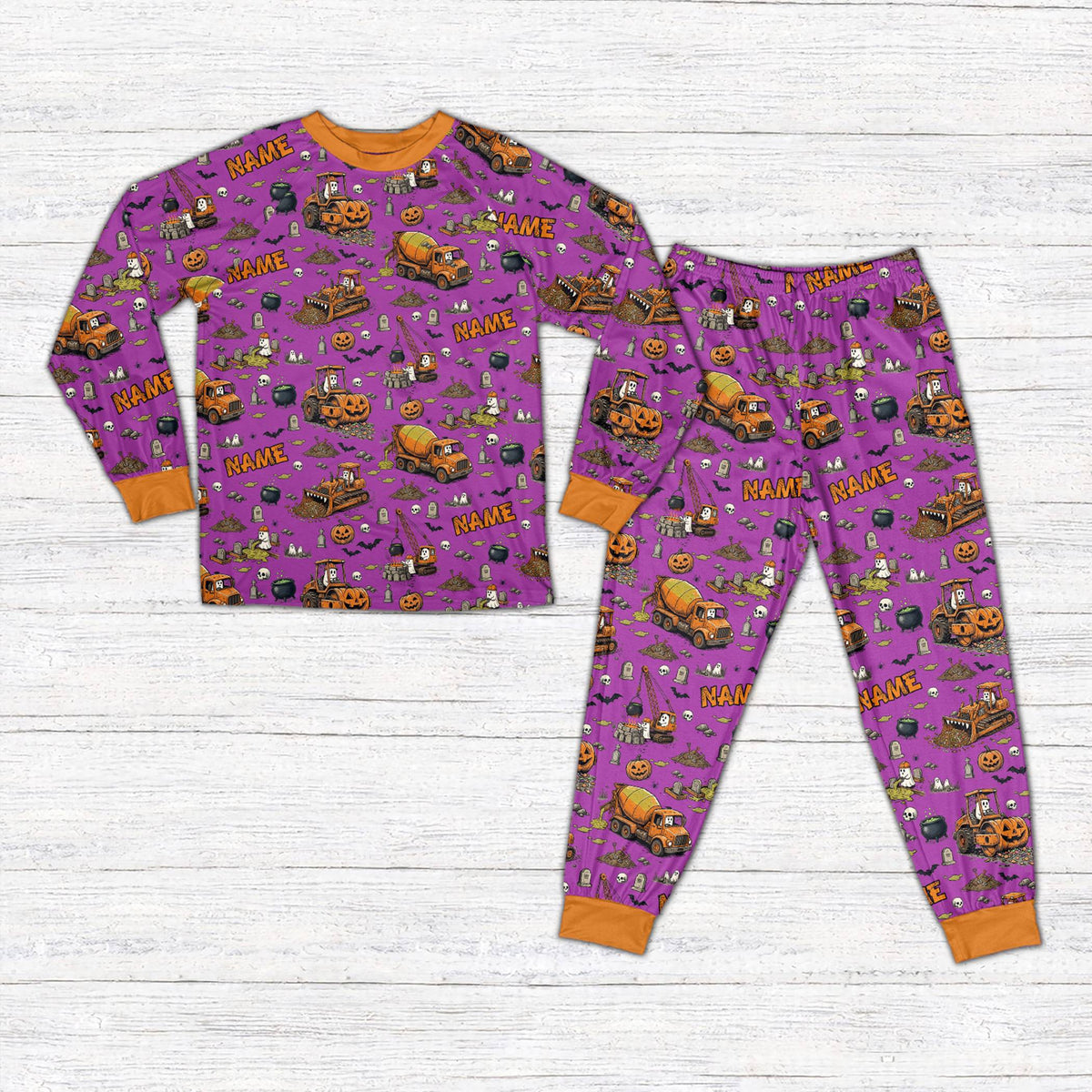 Front view of personalized Halloween pajama set featuring construction vehicles in purple
