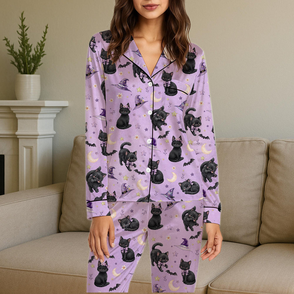 Lifestyle view of someone wearing the purple cat and bat Halloween pajamas
