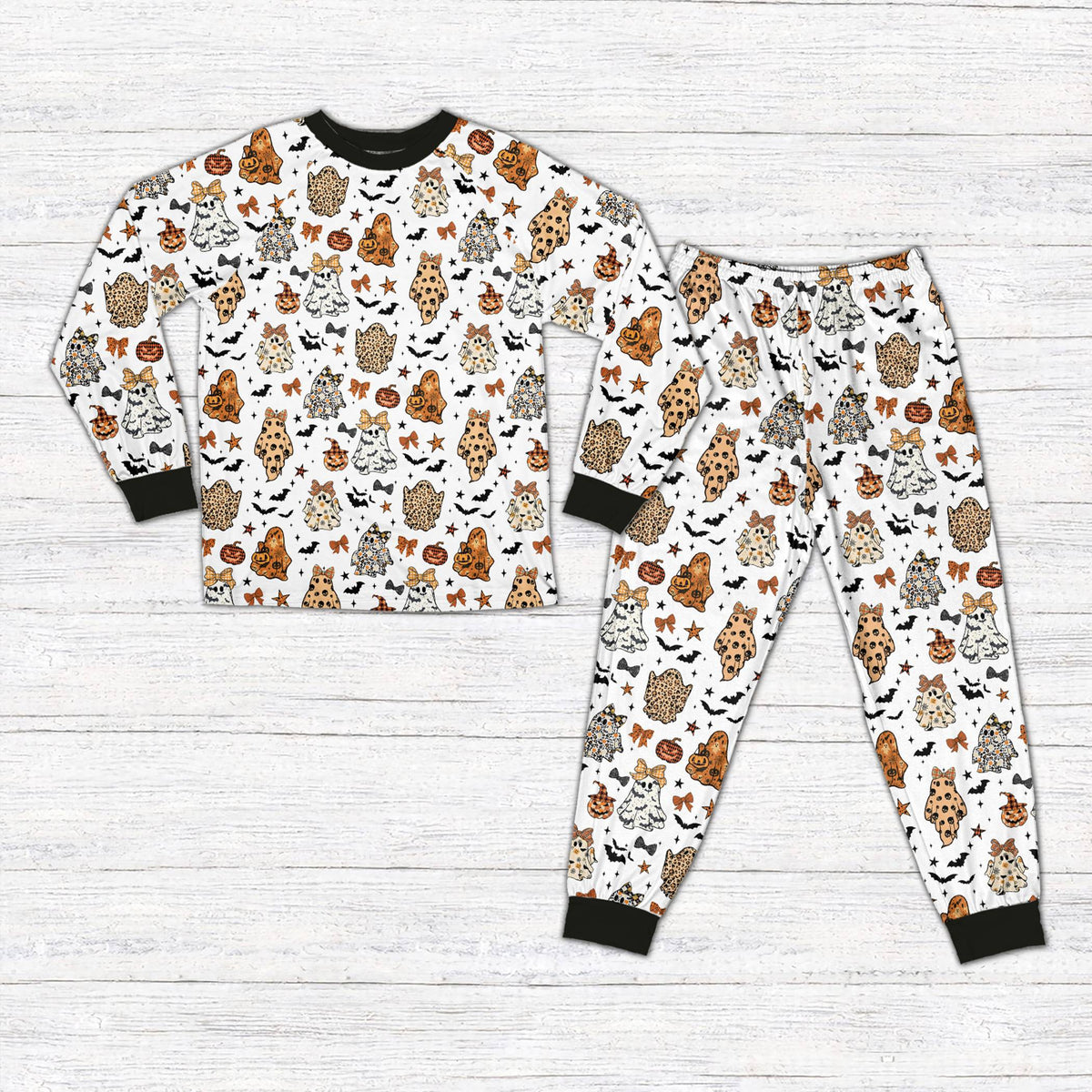 White halloween pajama set featuring leopard print ghosts and jack-o'-lanterns, front view