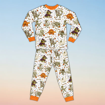 Family wearing matching family pajamas holiday sets with Halloween dinosaur design