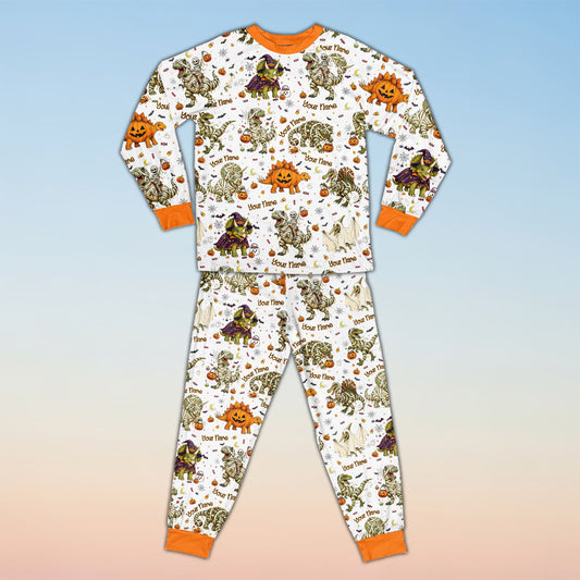 Family wearing matching family pajamas holiday sets with Halloween dinosaur design