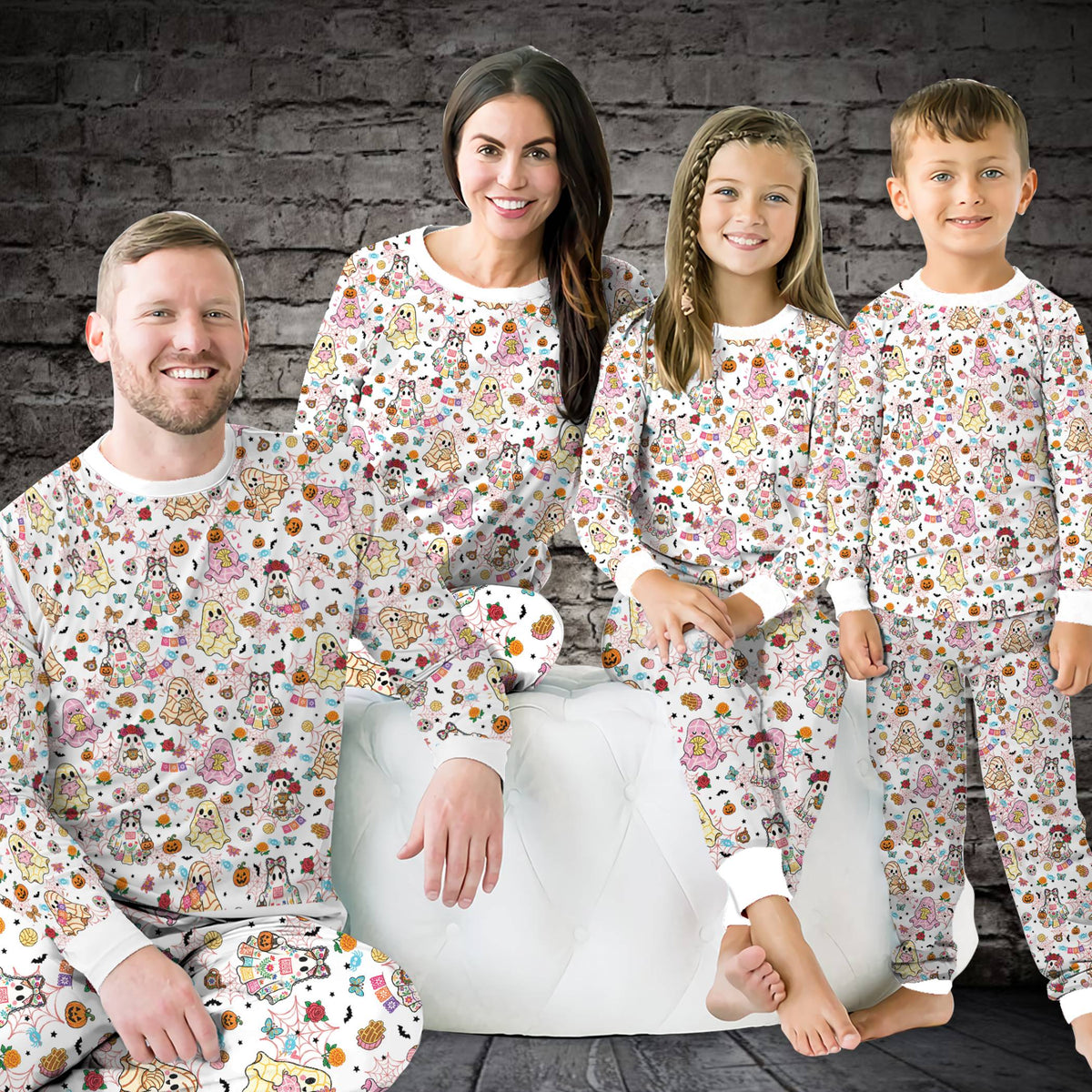 Lifestyle view of family wearing Halloween ghost matching family pajama sets