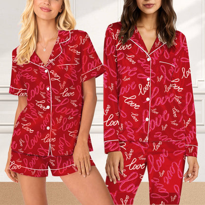 Close-up of the cursive love pattern and white piping on the red pajama set