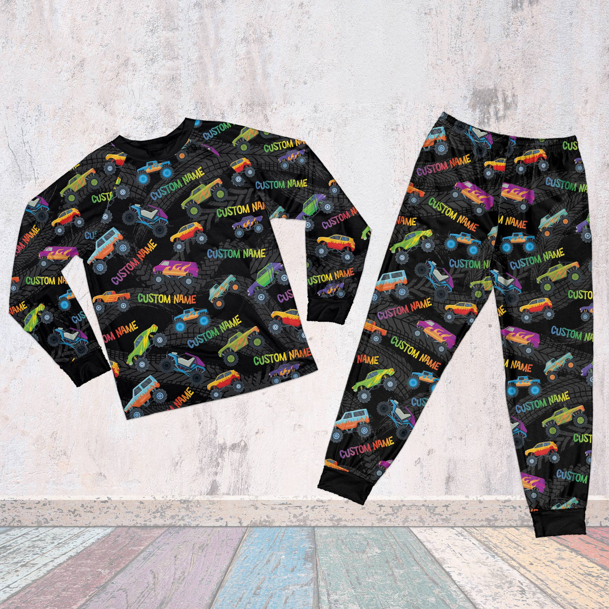 Family wearing matching personalized monster trucks pajama sets with custom names and numbers