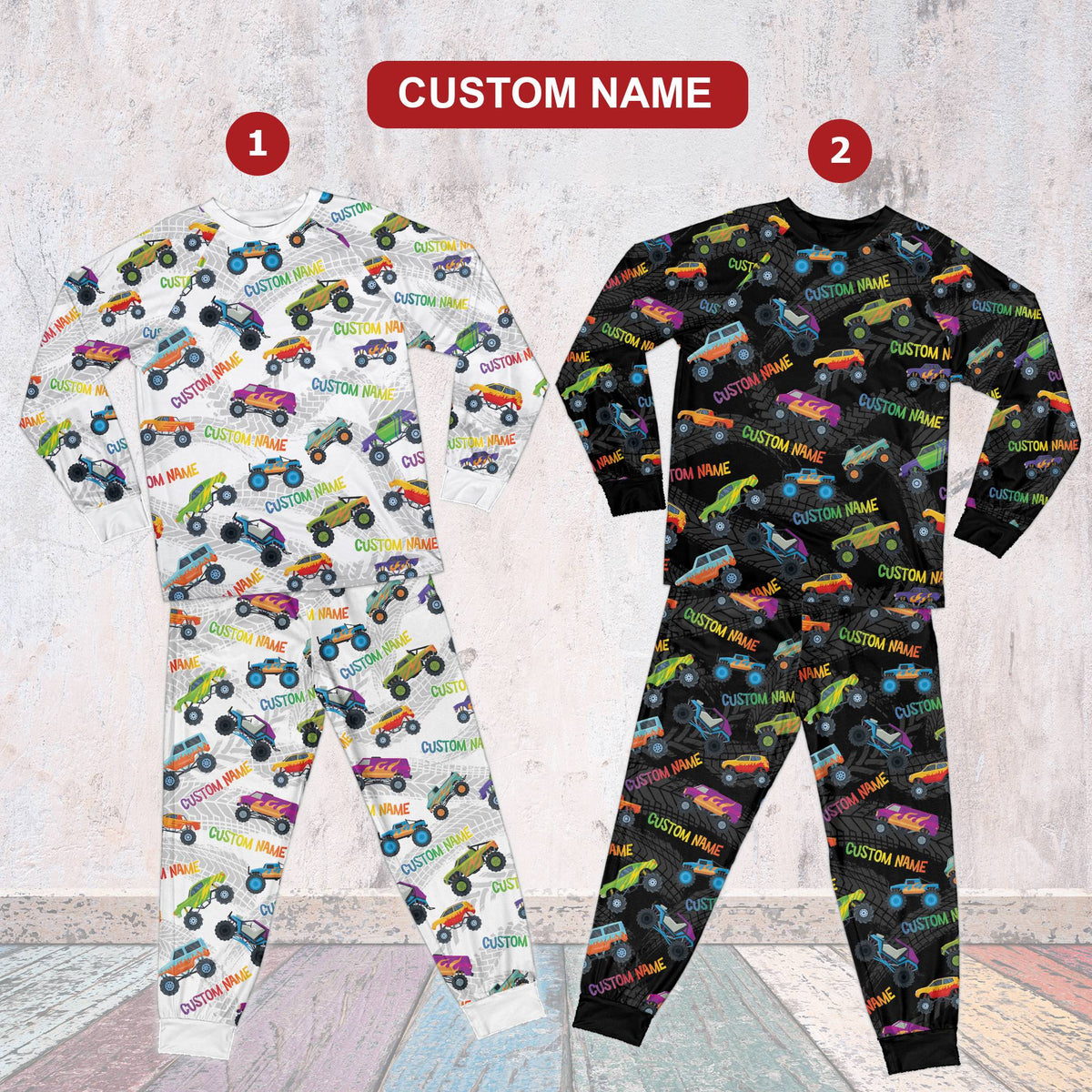 Front view of black personalized monster trucks pajama set with colorful graphics
