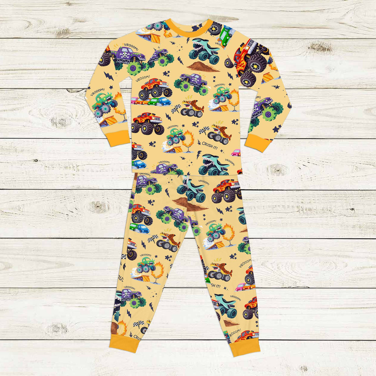 Yellow monster trucks pajama set front view