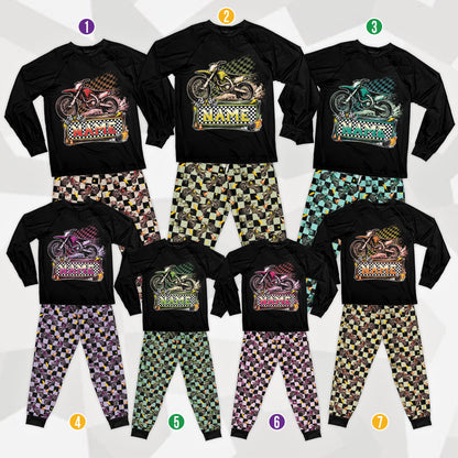 Front view of the motocross pajama set with black raglan shirt, dirt bike illustration, and checkered sleeves and pants