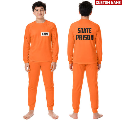 Family posing together in their matching orange prisoner pajama sets