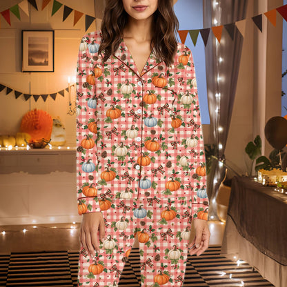 Detailed view of the orange pumpkins and pinecones on the pajama fabric