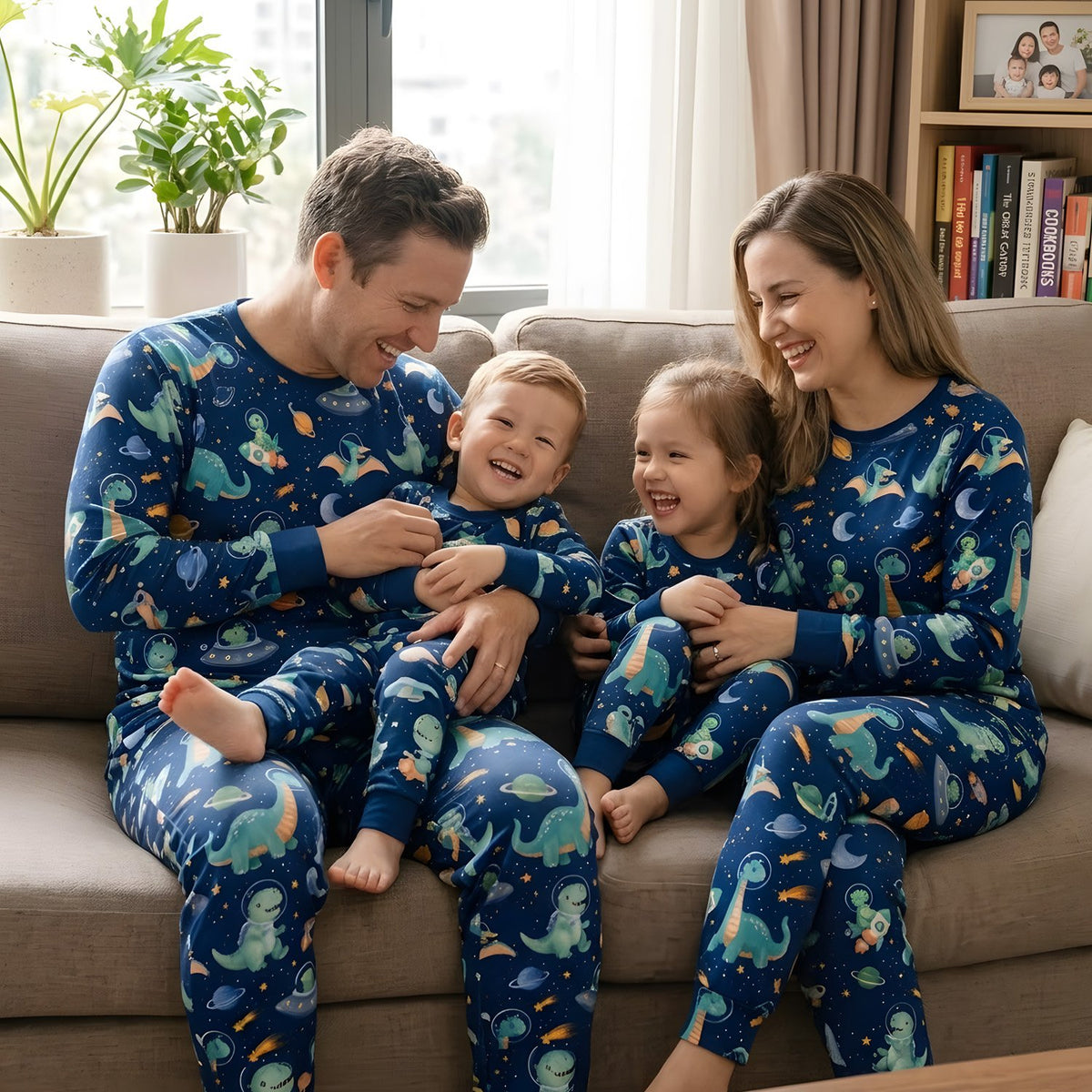 Lifestyle shot of a family wearing the navy space dinosaurs pajama set