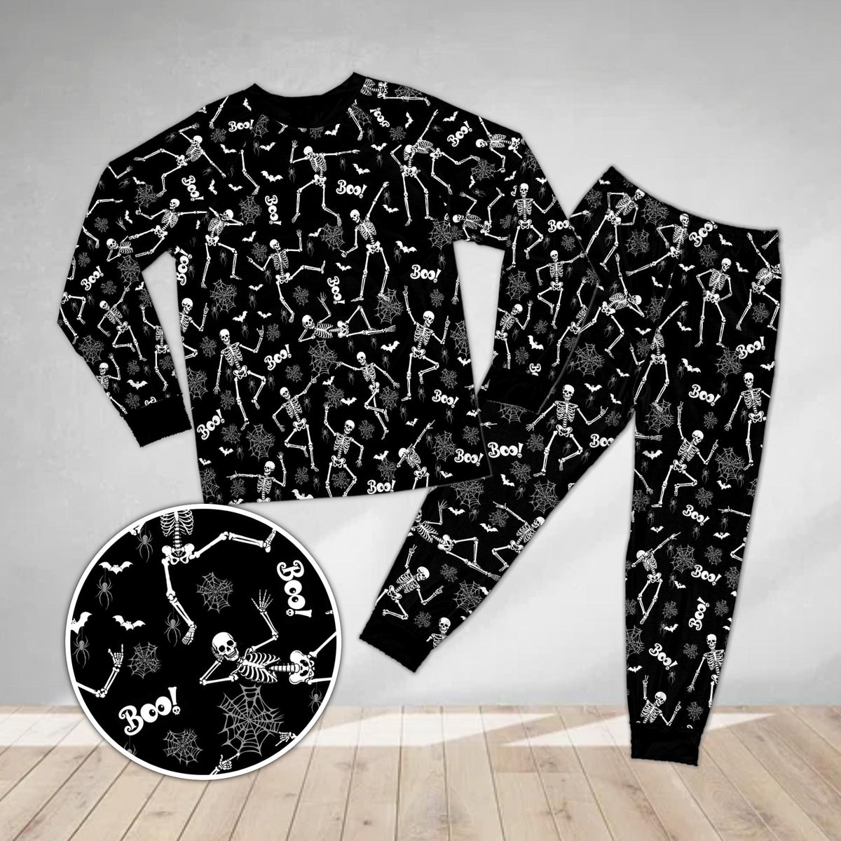 Main view of the spooky pajama set in black with dancing skeletons and bats print