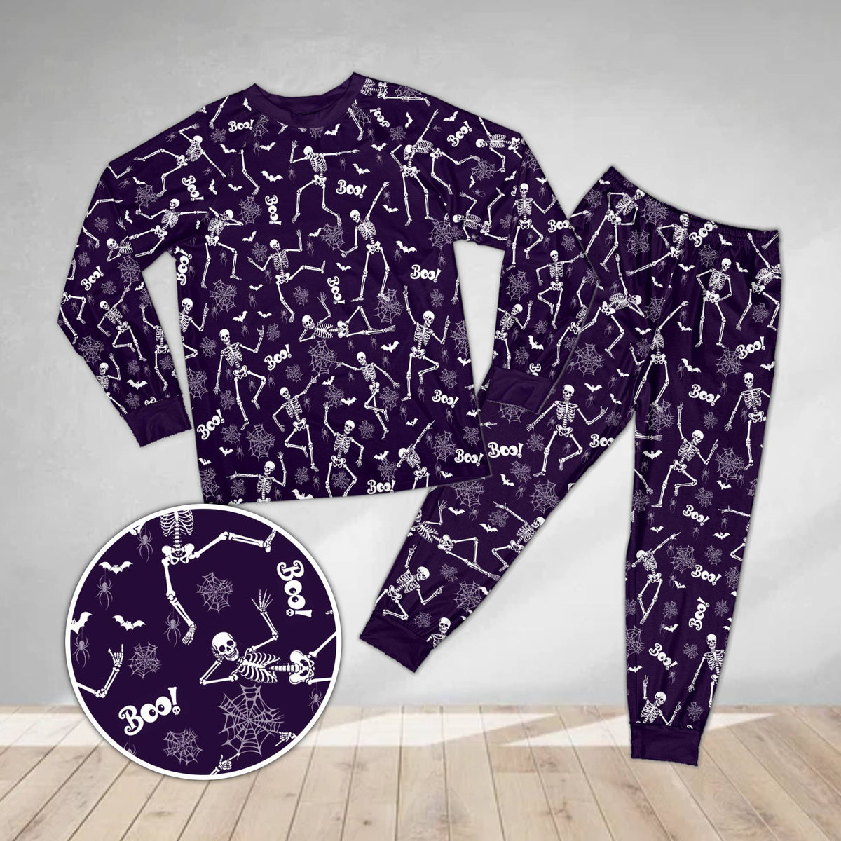 Front view of the spooky pajama set in purple featuring spiderwebs and skeletons
