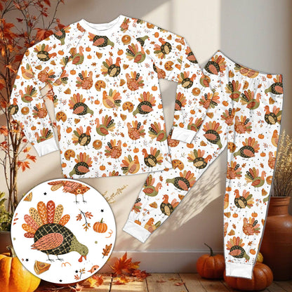Matching family pajama set with Thanksgiving turkey and pumpkin pie pattern on black background, front view