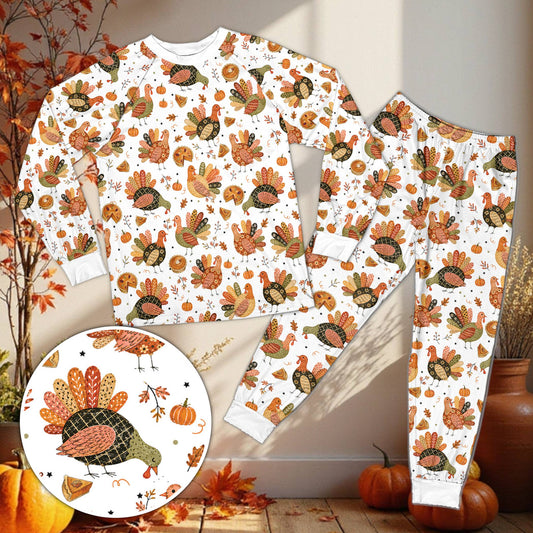 Matching family pajama set with Thanksgiving turkey and pumpkin pie pattern on black background, front view