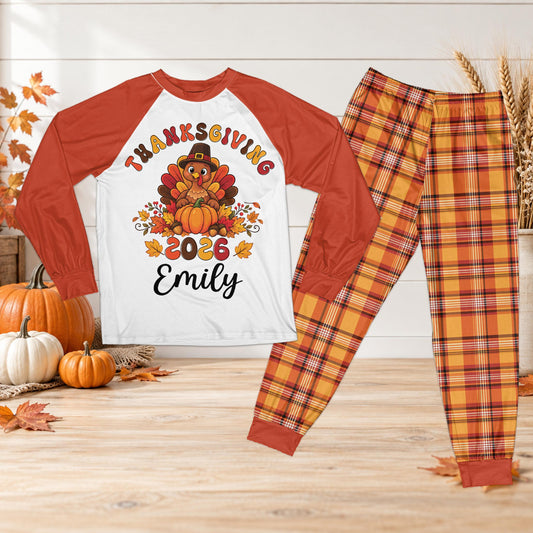 Personalized thanksgiving pajama set featuring a cartoon turkey design and orange red plaid pants, front view