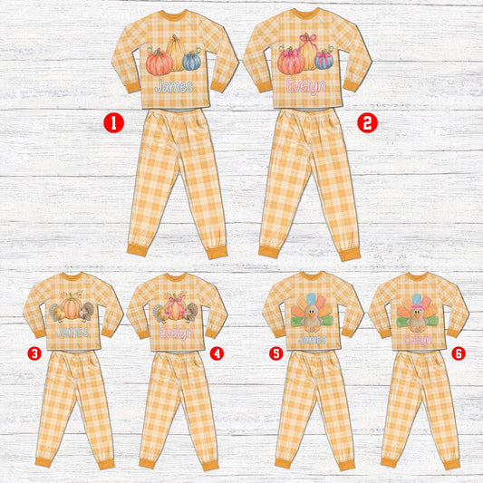 Personalized matching family xmas pajamas in light orange and cream plaid featuring Thanksgiving pumpkin graphics, front view