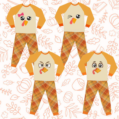 Front view of a smaller Thanksgiving pajama set with turkey face and plaid pants