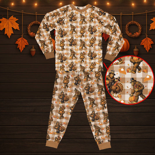 Main view of matching plaid family pajamas featuring a Thanksgiving Bigfoot design on a tan background