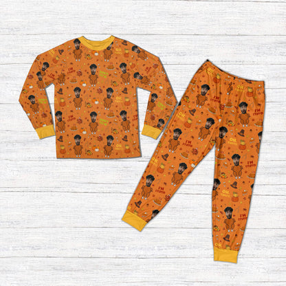 Orange personalized Thanksgiving pajama set with custom name and number, front view