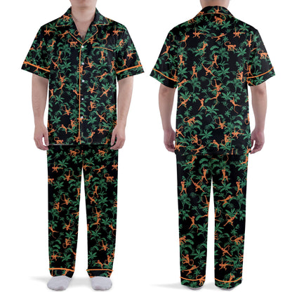 Tropical jungle monkeys pajama set featuring orange monkeys and green palm leaves on black background, front view