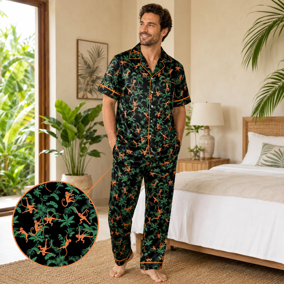 Close-up of adult in black tropical jungle pajama set showing orange piping