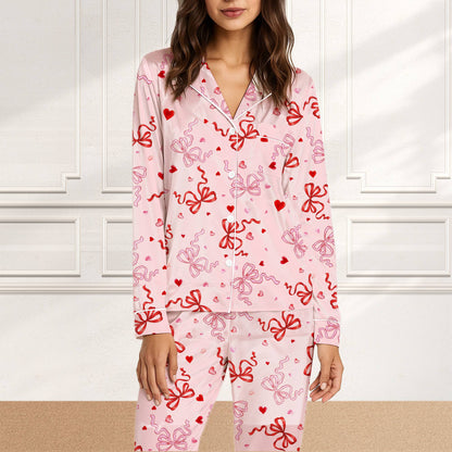 Front angle of the matching family pajama bottoms with hearts and ribbons