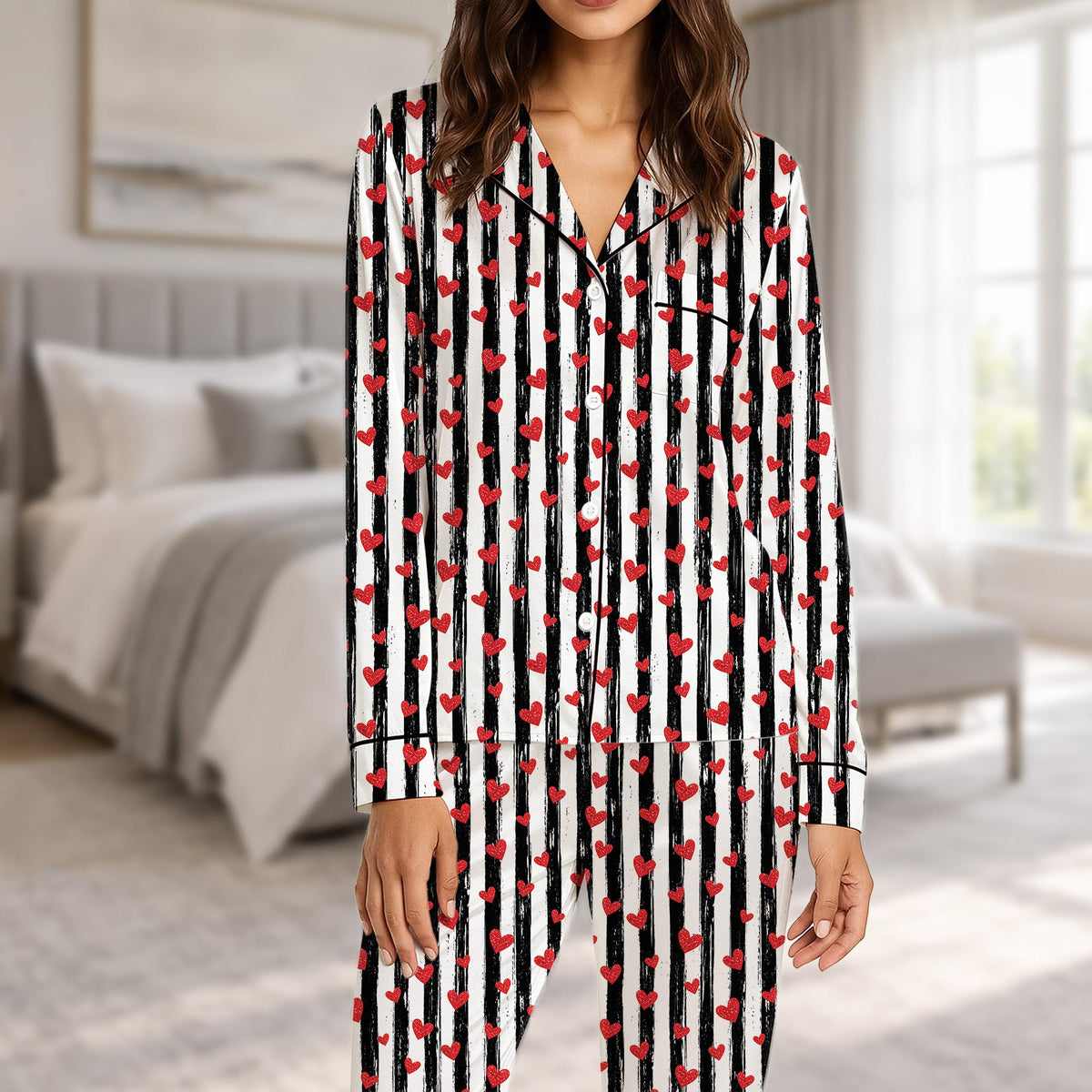 Matching family valentine's day pajama set in black and white stripes with red hearts, front view