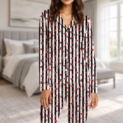 Matching family valentine's day pajama set in black and white stripes with red hearts, front view
