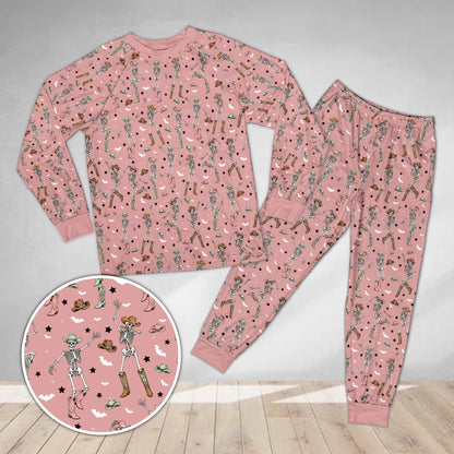 Pink background matching holiday family pajamas with cowboy skeletons