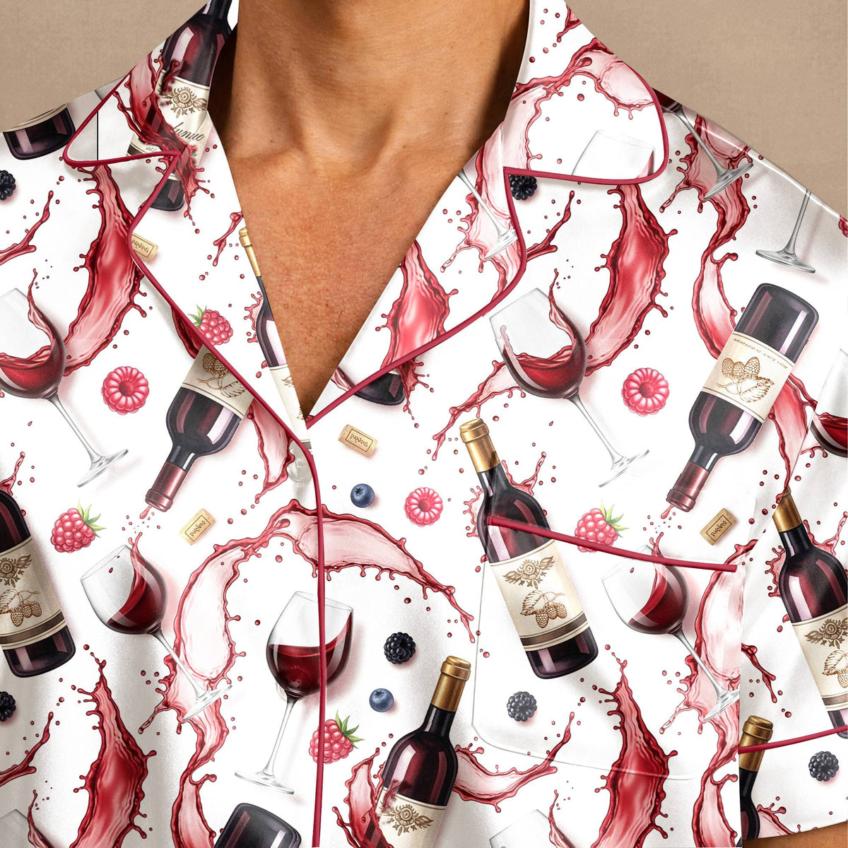 Close-up detail of the wine lover pajama set showing printed wine bottles, glasses, and corks