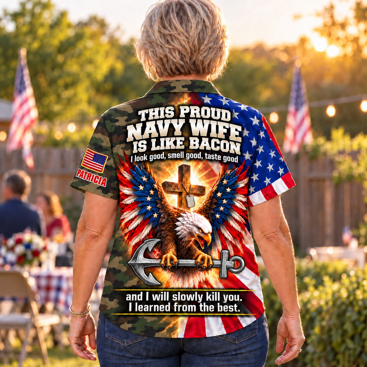 Back of the personalized This Proud Navy Wife Is Like Bacon Hawaiian shirt: camo body, American flag eagle gripping a steel anchor under a glowing cross and dog tags, custom name under the flag patch on the sleeve