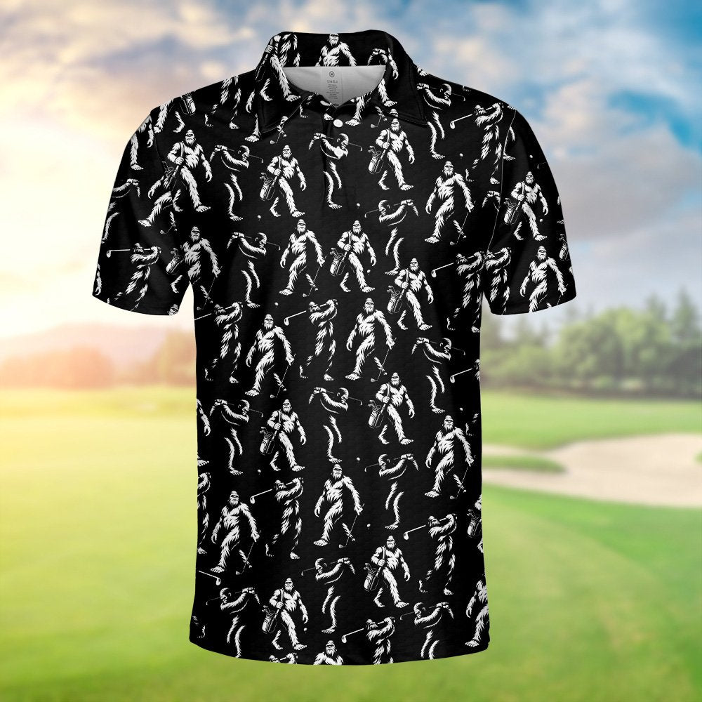 Black bigfoot polo shirt featuring white bigfoot figures golfing, close up front view
