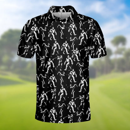 Black bigfoot polo shirt featuring white bigfoot figures golfing, folded front view